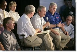 President George W. Bush speaks during a meeting with local officials and business leaders, including Mississippi Governor Haley Barbour, right, in Gulfport, Miss., Tuesday, Sept. 20, 2005.  White House photo by Eric Draper