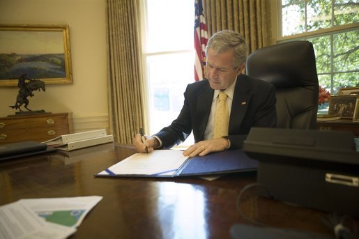 President George W. Bush signs into law H.R. 3169, the "Pell Grant Hurricane and Disaster Relief Act," which authorizes the Department of Education to waive requirements for Pell Grant repayments if student withdrawals from institutions of higher education are due to major disasters, Wednesday, Sept. 21, 2005, in the Oval Office. The President also signed into law two other hurricane-related bills: H.R. 3668, the "Student Grant Hurricane and Disaster Relief Act," and H.R. 3672, the "TANF Emergency Response and Recovery Act of 2005." White House photo by Eric Draper