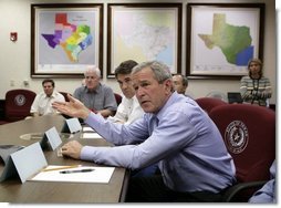 President George W. Bush speaks during a meeting with Texas officials, including Texas Governor Rick Perry, left, inside the Texas Emergency Operations Center in Austin, Texas, Saturday, Sept. 24, 2005. White House photo by Eric Draper