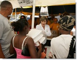 Laura Bush helps give out meals to families, while visiting a medical and food distribution site, Tuesday, Sept. 27, 2005 in Biloxi, Miss.  White House photo by Krisanne Johnson