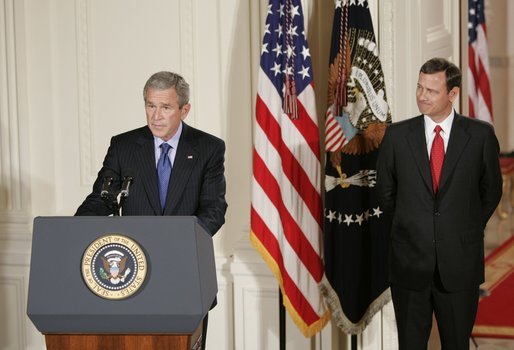 With Chief Justice John Roberts looking on, President George W. Bush makes remarks Thursday, Sept. 29, 2005, after the swearing-in ceremony in the East Room of the White House. Justice Roberts was confirmed earlier in the day by a 78-22 Senate vote. White House photo by Paul Morse