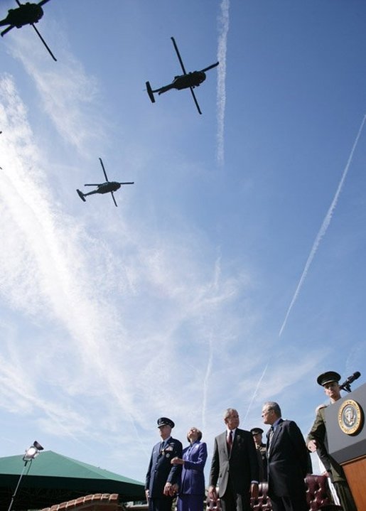 President George W. Bush stands with Defense Secretary Donald Rumsfeld during a helicopter flyover Friday, Sept. 30, 2005, during The Armed Forces Farewell Tribute in Honor of General Richard B. Myers and the Armed Forces Hail in Honor of General Peter Pace at Fort Myer's Summerall Field in Ft. Myer, Va. White House photo by Paul Morse
