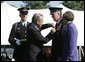 Defense Secretary Donald Rumsfeld pins a medal on General Richard B Myers, as Myers' wife, Mary Jo Myers, looks on Friday, Sept. 30, 2005, during The Armed Forces Farewell Tribute in Honor of General Richard B. Myers and the Armed Forces Hail in Honor of General Peter Pace at Fort Myer's Summerall Field in Ft. Myer, Va. White House photo by David Bohrer
