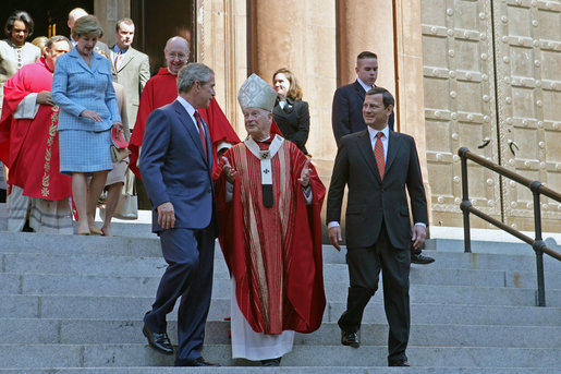President George Bush walks out of St. Matthew's Cathedral with Theodore Cardinal McCarrick and Supreme Court Chief Justice John Roberts after attending the 52nd Annual Red Mass in Washington, DC, Sunday, October 2, 2005. The Red Mass, a historical tradition within the Catholic Church, is held on the Sunday before the opening session of the Supreme Court. White House photo by Shealah Craighead