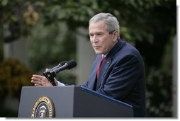 President George W. Bush responds to a question during Tuesday's news conference in the Rose Garden of the White House.  White House photo by Eric Draper