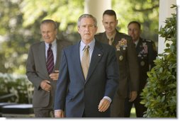 President George W. Bush walks to the Rose Garden Wednesday, Oct. 5, 2005, followed by Secretary of Defense Donald Rumsfeld, General Peter Pace, Chairman of the Joint Chiefs of Staff, and Gen. David Petraeus, former Commander of the Multinational Security and Transition Team in Iraq.  White House photo by Paul Morse