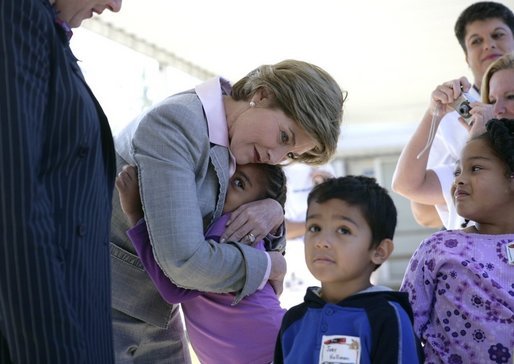 Laura Bush gives a hug to a student at Delisle Elementary School in Pass Christian, Miss., Tuesday, Oct. 11, 2005, as the school reopened for the first time since the area was struck by Hurricane Katrina. White House photo by Eric Draper