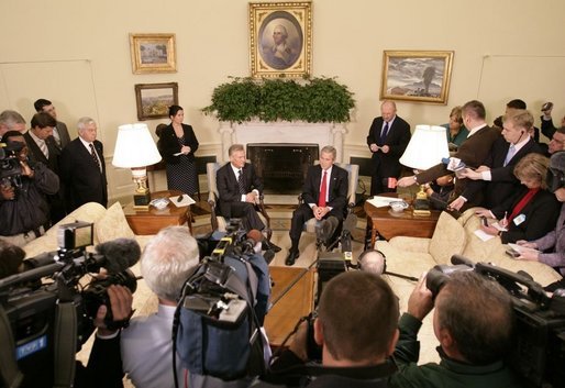 President George W. Bush and Poland's President Aleksander Kwasniewski meet with reporters in the Oval Office at the White House, Wednesday, Oct. 12, 2005 in Washington. White House photo by Eric Draper