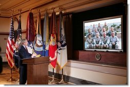 President George W. Bush gestures as he speaks with troops, from the U.S. Army's 42nd Infantry Division serving in Iraq, via video teleconference from the Eisenhower Executive Office Building in Washington, Thursday, Oct. 13, 2005.  White House photo by Paul Morse