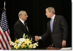President George W. Bush shakes hands with Pakistan's Ambassador Jehangir Karamat, after signing a book of condolences, Friday, Oct. 14, 2005 at the Pakistan Embassy in Washington, to express the condolences of the American people for those who suffered as a result of the recent earthquake that struck Pakistan. White House photo by Eric Draper