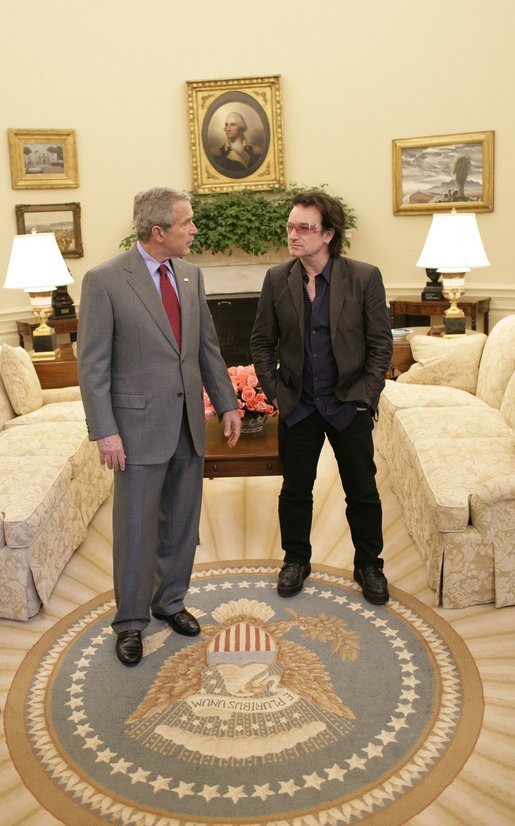 President George W. Bush and Bono discuss global AIDS and Africa policy in the Oval Office Wednesday, Oct. 19, 2005, following lunch in the White House. White House photo by Eric Draper
