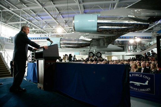President George W. Bush stands before the Boeing 707 aircraft that served President Ronald Reagan and six other presidents, as he addresses an audience at the Ronald Reagan Presidential Library, Friday, Oct. 21, 2005 in Simi Valley, Calif., at the dedication of the Air Force One Pavilion. White House photo by Eric Draper