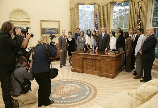 President George W. Bush poses for photos, Tuesday, Oct. 25, 2005 with the 2005 National Physical Fitness Champions, during their visit to the Oval Office at the White House. White House photo by Eric Draper