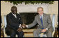 President George W. Bush welcomes Ghana President John A. Kufuor to the Oval Office at the White House, Wednesday, Oct. 26, 2005. President Kufuor arrived in Washington this week to promote trade, investment and tourism in Ghana. White House photo by Eric Draper