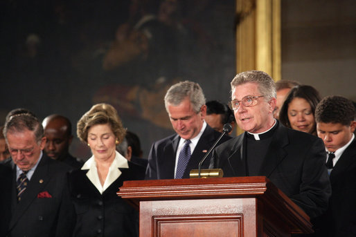 President George W. Bush and Laura Bush participate in a prayer led by Reverend Daniel Coughlin, House Chaplain, in honor of Rosa Parks during a wreath-laying ceremony in the Rotunda of the U.S. Capitol in Washington, D.C., Sunday Oct. 30, 2005. Rosa Parks passed away Monday, Oct. 24th. White House photo by Shealah Craighead
