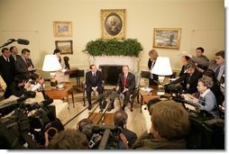 President George W. Bush talks to reporters during a visit with Italian Prime Minister Silvio Berlusconi in the Oval Office at the White House, Monday, Oct. 31, 2005 in Washington.  White House photo by Eric Draper