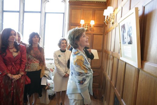 Mrs. Laura Bush looks over a photographic exhibit during a luncheon in Mar del Plata Saturday, Nov. 5, 2005, hosted by Argentine First Lady Mrs. Cristina Fernandez de Kirchner, far left. White House photo by Krisanne Johnson