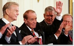 Former Mississippi Congressman and decorated war veteran, G.V. Sonny Montgomery, center, waves as he is introduced, and applauded by his fellow recipients of the 2005 Presidential Medal of Freedom, awarded Wednesday, Nov. 9, 2005 in the East Room. From left to right are, Paul Harvey, Montgomery, General Richard B. Myers and golf legend Jack Nicklaus.  White House photo by Shealah Craighead
