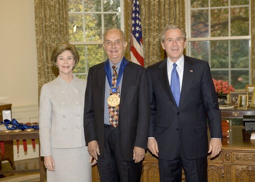 President George W. Bush and Laura Bush stand with author Louis Auchincloss, recipient of the 2005 National Medal of Arts, in the Oval Office Thursday, Nov. 10, 2005. White House photo by Eric Draper
