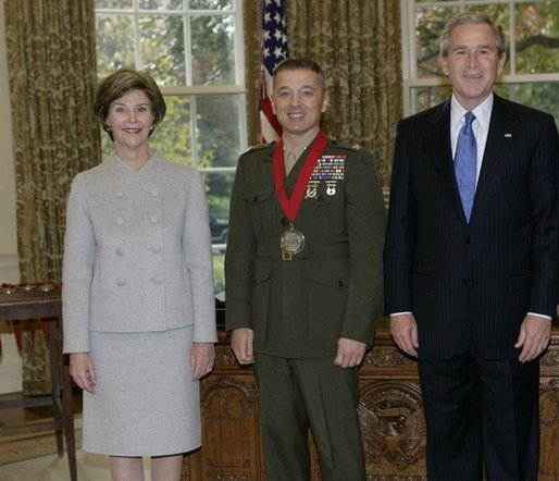 President George W. Bush and Laura Bush stand with 2005 National Humanities Medal recipient U.S. Marine Matthew Bogdanos, also an Assistant District Attorney in New York, Thursday, Nov. 10, 2005 in the Oval Office at the White House. White House photo by Eric Draper