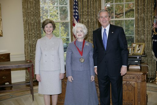 President George W. Bush and Laura Bush stand with 2005 National Humanities Medal recipient Judith Martin, author and columnist, Thursday, Nov. 10, 2005 in the Oval Office at the White House. White House photo by Eric Draper