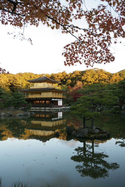 The Golden Pavilion Kinkakuji Temple is reflected in the pool as the sun rises over Kyoto, Japan, Wednesday, Nov. 16, 2005. White House photo by Paul Morse