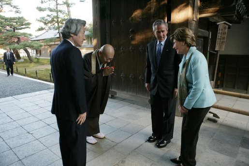 President and Mrs. Bush are greeted by the Reverend Raitei Arima, Chief Priest at the Golden Pavilion Kinkakuji Temple, and Japan’s Prime Minister Junichiro Koizumi, at the doors of the temple Wednesday, Nov. 16, 2005, in Kyoto. White House photo by Paul Morse