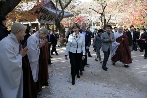 President George W. Bush and Laura Bush smile as they are greeted by monks Thursday, Nov. 17, 2005, at the Bulguksa Temple in Gyeongju, Korea. White House photo by Eric Draper