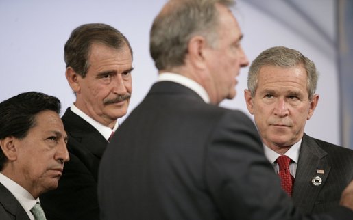 Canada's Prime Minister Paul Joseph Martin has the attention of President George W. Bush and fellow leaders of the Americas Friday, Nov. 18, 2005, as they meet at the Chosun Westin Hotel in Busan, Korea. Listening are, from left: Peru President Alejandro Toledo and Mexico President Vincente Fox. White House photo by Eric Draper