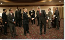 President George W. Bush and Russian President Vladimir Putin exchange handshakes Friday, Nov. 18, 2005, after their meeting in Busan, Korea, prior to the opening of the 2005 APEC conference.  White House photo by Eric Draper