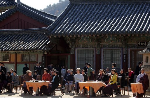Sitting in the Korean sunlight, Laura Bush is joined by spouses of APEC leaders at the Beomeosa Temple in Busan for a morning tea ceremony. White House photo by Shealah Craighead