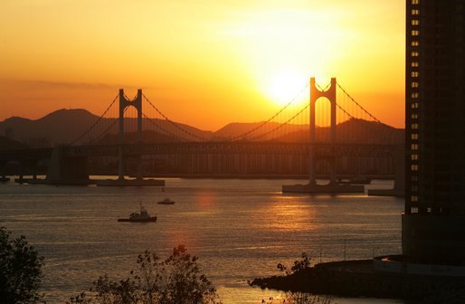 The sun sets over Busan's Gwangan Grand Bridge Friday, Nov. 18, 2005. White House photo by Shealah Craighead