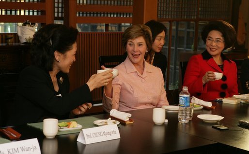 Mrs. Bush tips her teacup to Professor Chung Myung-wha during a discussion Saturday, Nov. 19, 2005, with women leaders in Busan, Korea. White House photo by Shealah Craighead