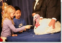 President George W. Bush invites the children of Clarksville Elementary School on stage to pet "Marshmallow", the National Thanksgiving Turkey, during the Tuesday, November 22, 2005 pardoning ceremony, held in the Eisenhower Executive Office Building in Washington.  White House photo by Shealah Craighead