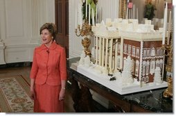 Laura Bush stands before the White House gingerbread house, Wednesday, Nov. 30, 2005, as she answers questions during the press preview of the White House Christmas decorations.  White House photo by Shealah Craighead