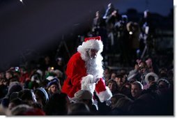 Santa goes into the audience to sing a song, Thursday evening, Dec. 1, 2005, during the Pageant of Peace and the lighting of the National Christmas Tree on the Ellipse in Washington.  White House photo by Paul Morse