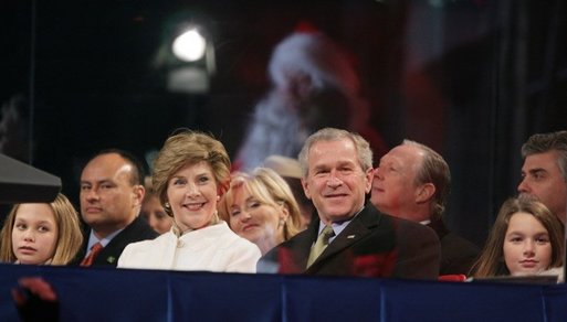 President George W. Bush and Laura Bush watch the holiday entertainment, Thursday evening, Dec. 1, 2005, during the Pageant of Peace and the lighting of the National Christmas Tree on the Ellipse in Washington. White House photo by Paul Morse