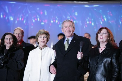 President George W. Bush and Laura Bush join holiday entertainers Thursday evening, Dec. 1, 2005, on stage during the Pageant of Peace and lighting of the National Christmas Tree festivities on the Ellipse in Washington. White House photo by Paul Morse