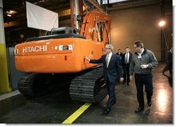 President George W. Bush tours the John Deere-Hitachi excavator assembly line, Monday, Dec. 5, 2005 with operations manager Ron Morrison, prior to his remarks on the economy and tax relief to an audience in Kernersville, N.C.  White House photo by Eric Draper