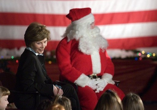 Laura Bush talks with a group of children as she visits the Naval and Marine Corps Reserve Center in Gulfport, Miss., Monday, Dec. 12, 2005, where she showed them White House holiday video featuring the Bush's dogs "Barney and Miss Beazley." White House photo by Shealah Craighead