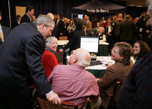 President Bush leans over to view a computer screen as he visits with participants Tuesday, Dec. 13, 2005, at the Medicare Prescription Drug Educational and Enrollment Event at the Greenspring Village Retirement Community in Springfield, Va. White House photo by Paul Morse