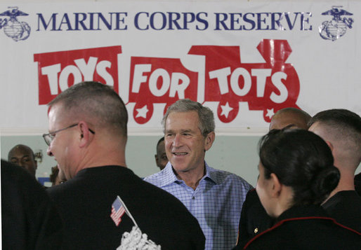 President George W. Bush meets with U.S. Marines working Monday, Dec. 19, 2005 at the "Toys for Tots" collection center at the Naval District Washington Anacostia Annex in Washington, D.C. White House photo by Kimberlee Hewitt