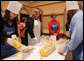 Student participants in the Youth Service Opportunities Project of Washington, D.C.'s Cardozo Senior High School joined Mrs. Laura Bush and her staff, Monday, Dec. 19, 2005, in assembling sandwiches for Martha's Table's mobile soup kitchen. White House photo by Shealah Craighead