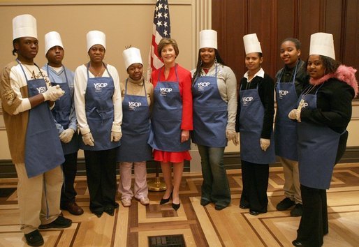 Mrs. Laura Bush and students at Cardozo Senior High School pose for pictures Monday, Dec. 19, 2005, in Washington, D.C. Mrs. Bush was on hand to join the Youth Services Opportunities Project in assembling sandwiches for Martha's Table's mobile soup kitchen. White House photo by Shealah Craighead