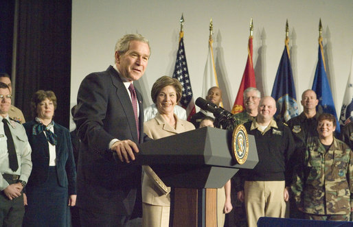 With Mrs. Laura Bush looking on, President George W. Bush addresses military medical caregivers Wednesday, Dec. 21, 2005, before visiting with the wounded at the National Naval Medical Center in Bethesda, Md. The President told the caregivers, ". On behalf of a grateful nation, thanks for doing your duty, thanks for serving, thanks for being an important part of this march for freedom; and thanks, most of all, for bringing comfort and aid and solace to those who have been hurt on the battlefield and their families." White House photo by Paul Morse