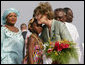 Mrs. Laura Bush embraces 10-year-old Aisha Garuba Sunday, Jan. 15, 2006, after she presented Mrs. Bush with flowers upon her arrival at Kotoka International Airport in Accra, Ghana. White House photo by Shealah Craighead