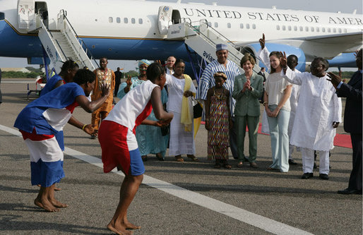 Mrs. Laura Bush and her daughter Barbara Bush are greeted by a cultural dance troupe upon their arrival Sunday, Jan. 15, 2006 at Kotoka International Airport in Accra, Ghana. White House photo by Shealah Craighead