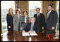 President George W. Bush prepares to sign a Presidential Proclamation, Monday, Jan. 30, 2006 in the Oval Office, in honor of the fourth anniversary of the USA Freedom Corps. Joining President Bush, from left to right, are Kathy Wills, deputy director of USA Freedom Corps; Desiree Sayle, director of USA Freedom Corps; Liz DiGregorio, acting director Office of Community Preparedness DHS; Gaddi Vasquez, director of Peace Corps and David Eisner, CEO the Corporation for National and Community Service. White House photo by Paul Morse