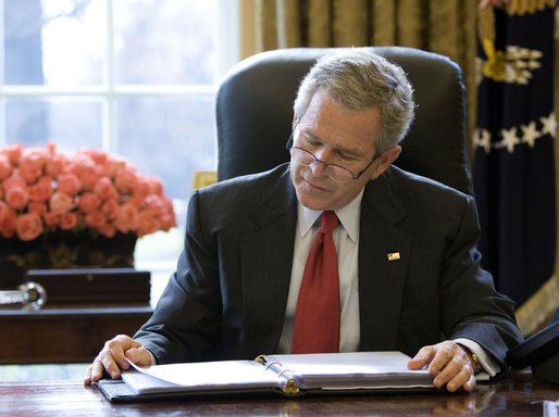 President George W. Bush reads over a draft of his State of the Union speech in the Oval Office Tuesday morning, Jan. 31, 2006, in preparation for the annual address to the nation scheduled for this evening. White House photo by Eric Draper