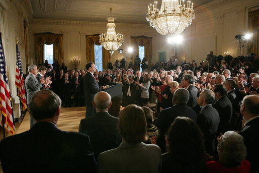President George W. Bush, left, listens as newly confirmed U.S. Supreme Court Justice Samuel Alito addresses an audience, Tuesday, Feb. 1, 2006 in the East Room of the White House, prior to being sworn-in by U.S. Supreme Court Chief Justice John Roberts. White House photo by Paul Morse